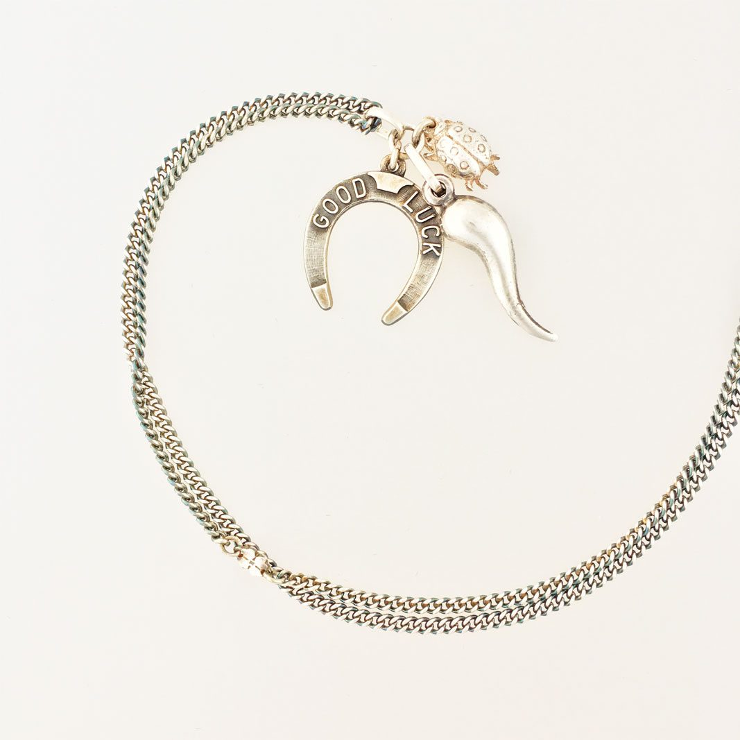 Lucky Necklace #8 is made from vintage sterling silver chain and three vintage sterling silver charms with symbols that are supposed to bring luck.